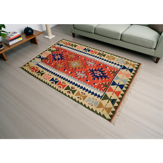 Handwoven in Turkey by skilled Anatolian artisans, this vintage Oushak kilim showcases time-honored flatweaving traditions...