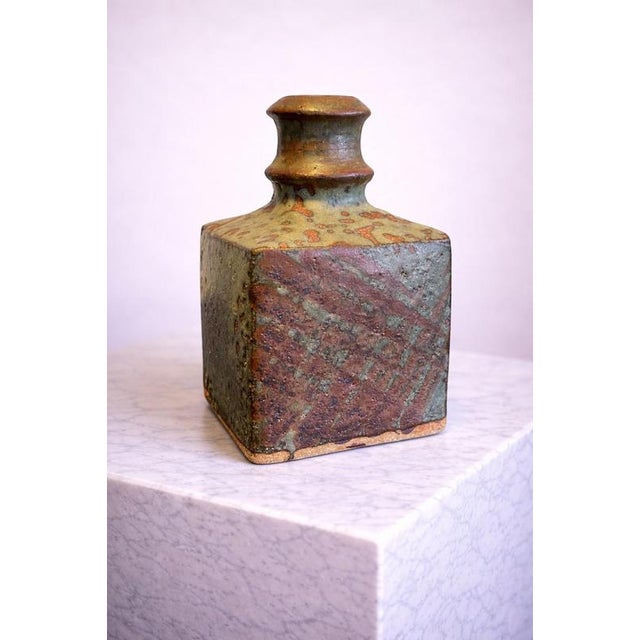 A beautifully expressive Japanese studio pottery vase dating to the mid-20th century, embodying the quiet elegance and...