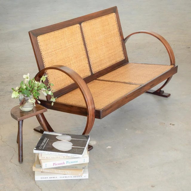 Beautiful Art Deco settee with rosewood arms and frame from France, 1940's. Striking large circular arms and newly woven...
