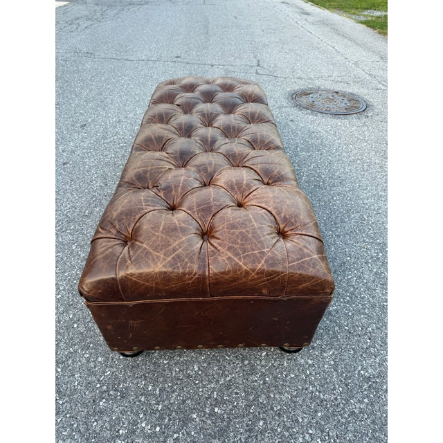 Gorgeous Berkshire leather ottoman purposefully distressed with aged high quality leather. Beautiful craftsmanship and...