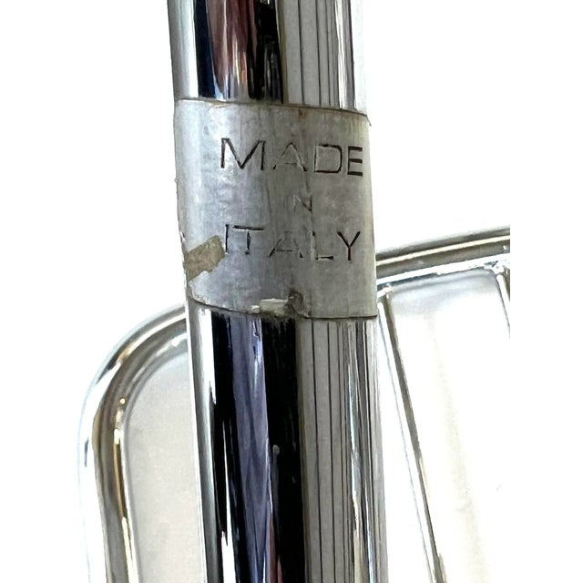 each of unique fluid form with cantilevered seat flanked by padded arms; each with 'made in italy' labels; with newly...