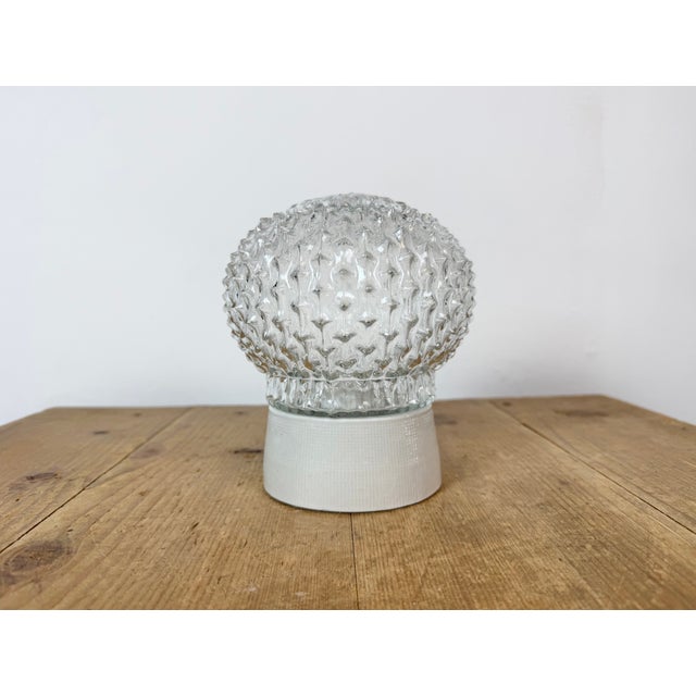 Vintage industrial ceiling or wall light made in former Czechoslivakia during the 1970s. It features a white porcelain...