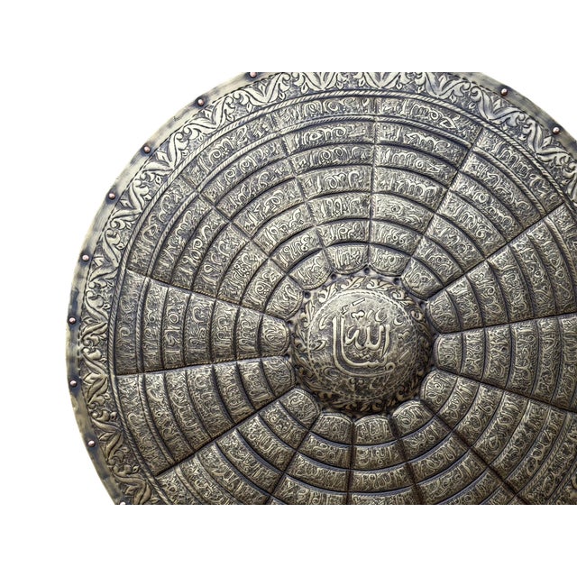 Arabic calligraphy has long been more than written language. Across Islamic metalwork traditions, sacred words were often...