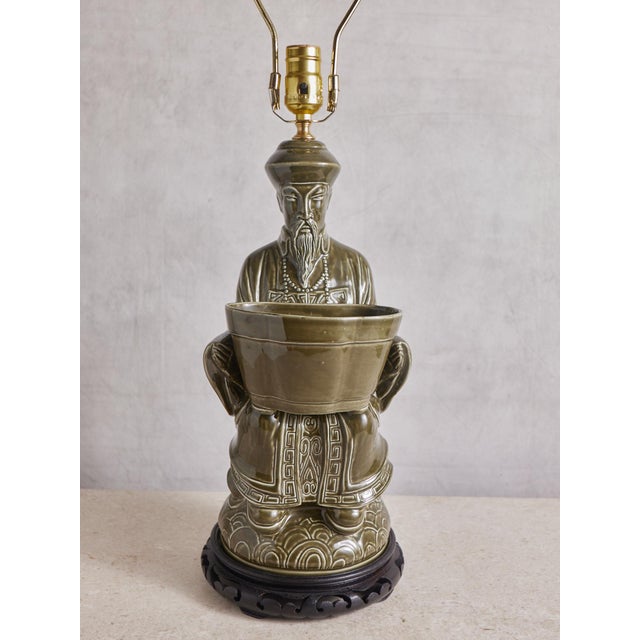 Freshly rewired, beautiful muted olive green ceramic table lamp on a wood base with a lovely brass finial. The perfect...
