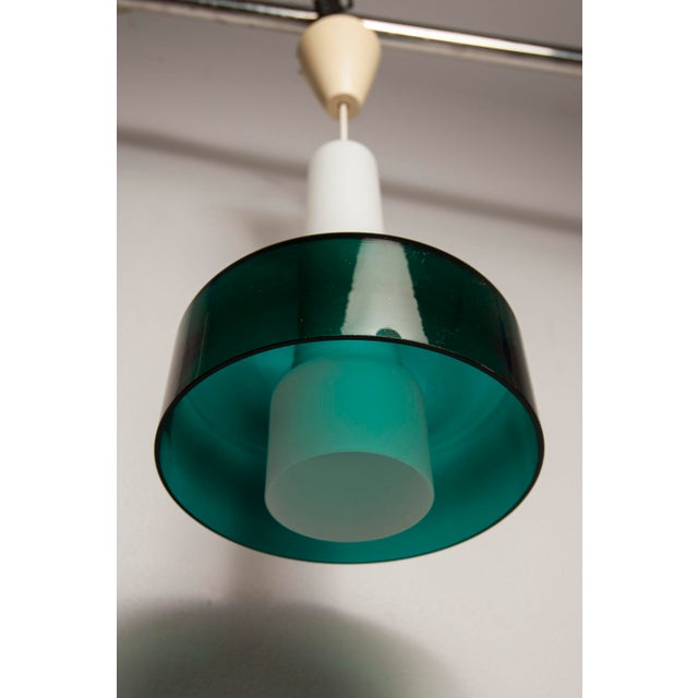 Vintage Scandinavian pendant light in two parts from the 1960s. The first part is made of white opaline glass and the...