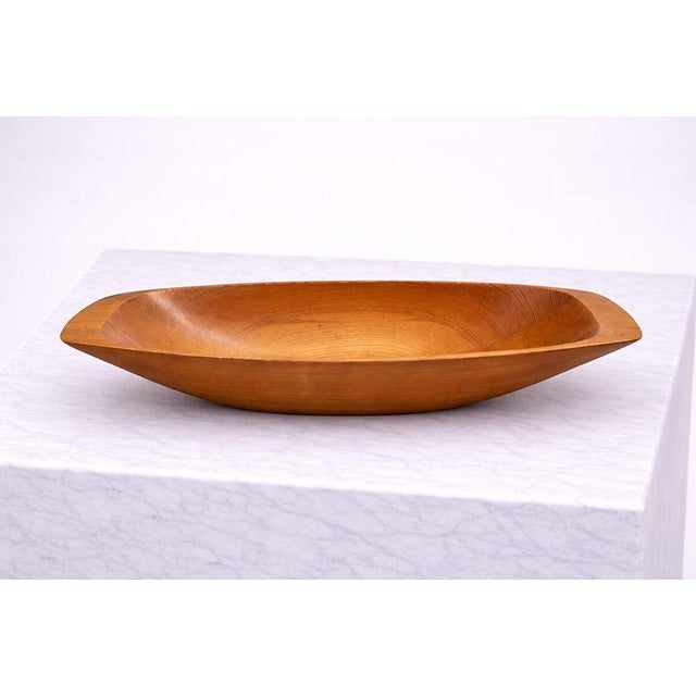 A beautifully sculpted hand-carved pine bowl by Swedish artisan Stig Sandqvist, dating to the 1970s. This elongated,...