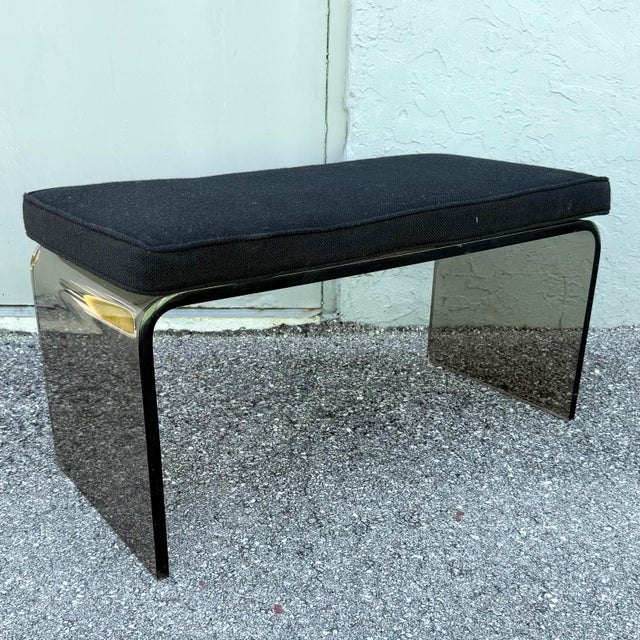 A sleek Mid-Century Modern waterfall bench crafted from sculptural smoked lucite, showcasing the clean lines and...