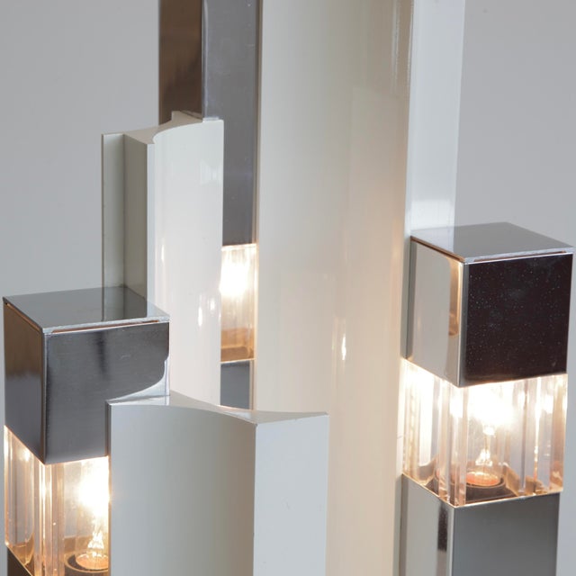 Cubic' table lamp with a nickel-plated and partially cream-coloured painted metal base. Three illuminated acrylic inserts...