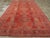 A Vintage Turkish Oushak room size carpet with a central column of lozenges, cruciforms, and bent leaf brackets, flanked...