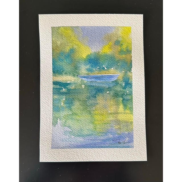 In the coolness of the morning, blue boat awaits. Is there any sight more peaceful than a boat on the water?