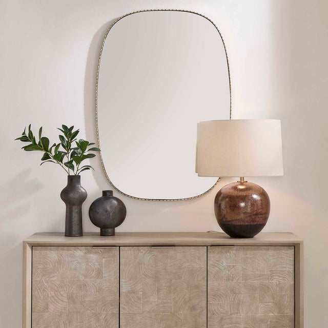 This Elegant, Elongated Mirror Features A Slender Iron Frame With A Scalloped Front Edge, Finished In A Distressed Antique...