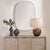 This Elegant, Elongated Mirror Features A Slender Iron Frame With A Scalloped Front Edge, Finished In A Distressed Antique...