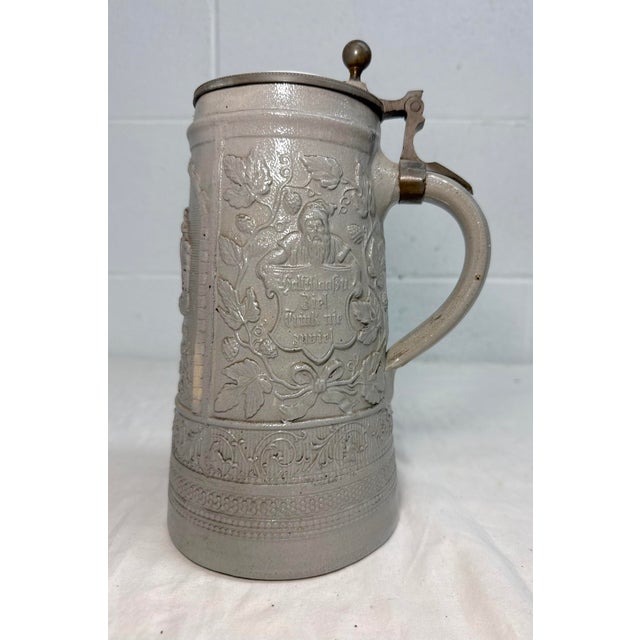 Up for sale is a high quality antique lidded German salt glazed stoneware beer stein made in the 19th century. It's made...