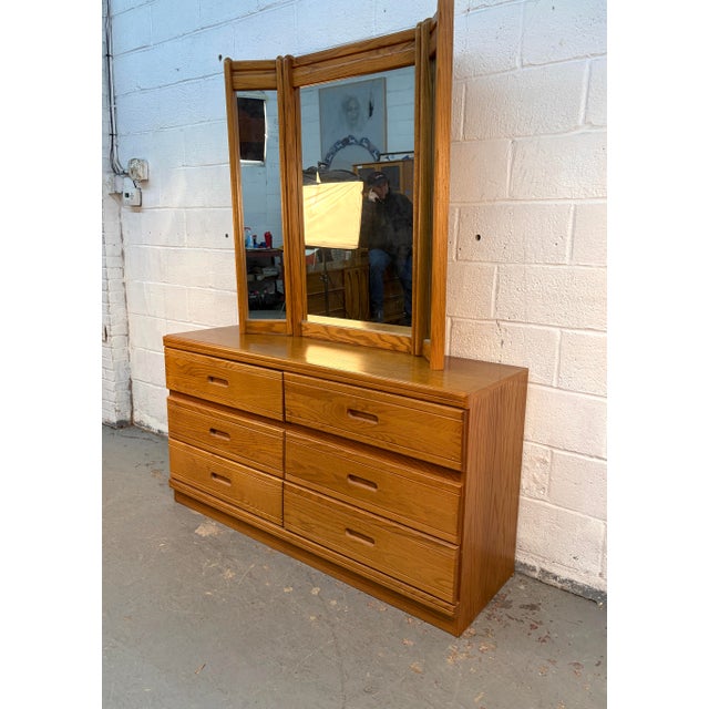 This classic "lowboy" style dresser is crafted from solid oak with a warm, honey-toned finish that beautifully showcases...
