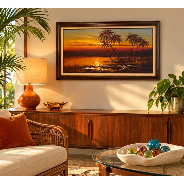 A beautiful sunset beach scene captured in a large, framed oil painting, signed by the artist. Enjoy the serene oceanfront...