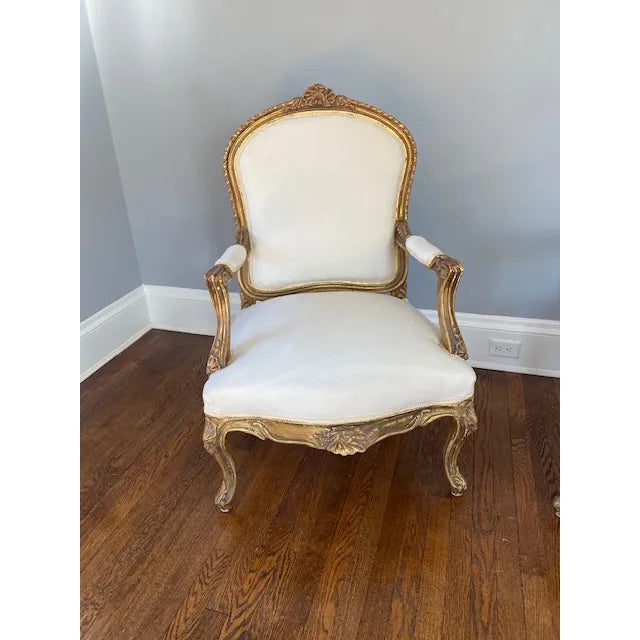 These generously sized French gilt armchairs are unparalleled in beauty and condition. They are likely from the late 1800s...