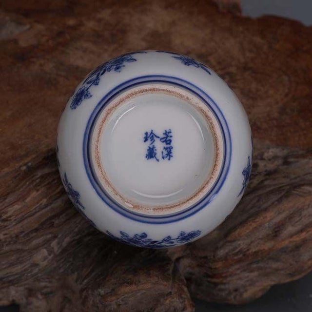 Classic Chinese porcelain lidded jar hand decorated in deep cobalt blue and crisp white. Detailed chrysanthemum floral...