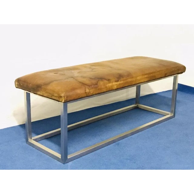 The leather part of the bench is in original condition and patina and construction is new made of stainless steel.