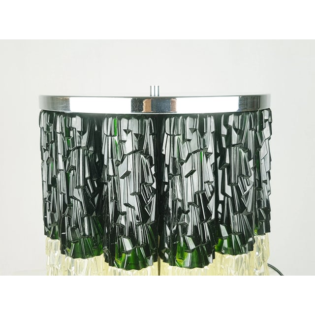 This large table lamp was produced in Italy in the 1960/70s. It is made from a doble row of plastic cylinders in yellowed...