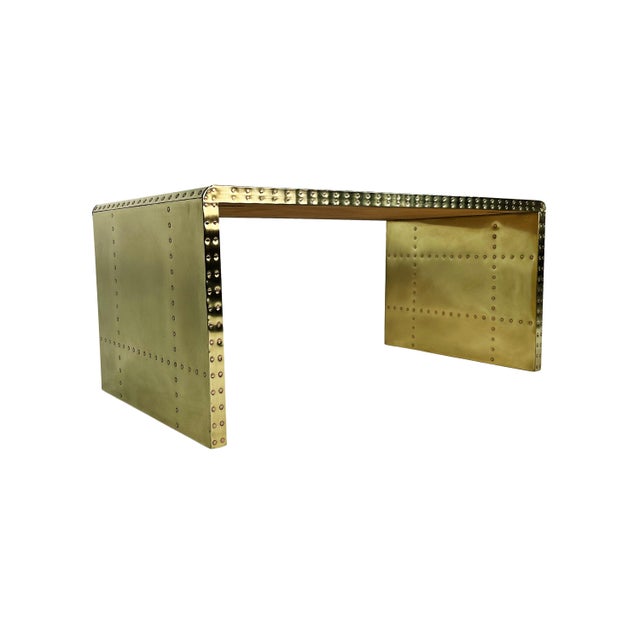 Vintage brass-clad coffee table with rounded "waterfall" style edges and copper nailheads. Although brass shows some signs...