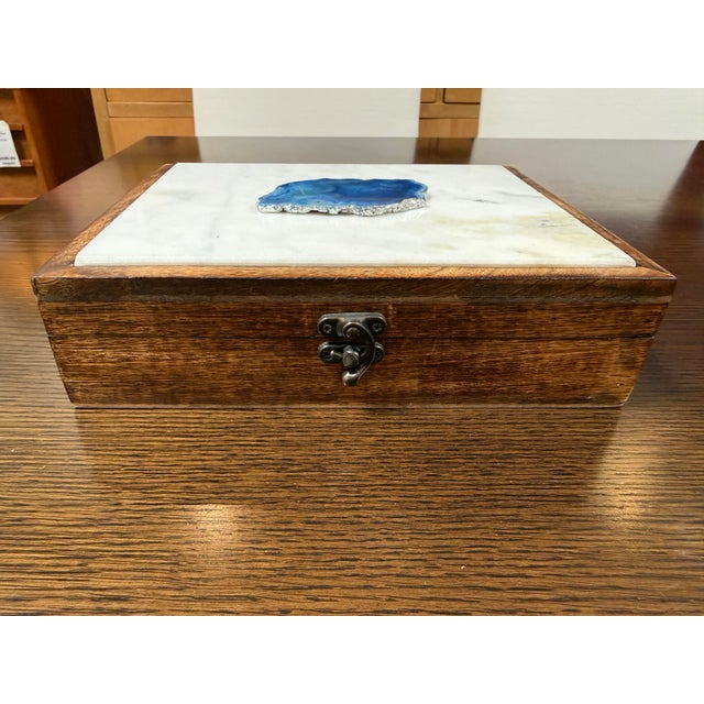 Design Plus Gallery presents a Wooden Keepsake Box with Agate Slice. The box is made of solid wood with a medium brown...