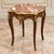 Elegant French style side table featuring a luxurious multicolor marble top beautifully complemented by ornate bronze and...