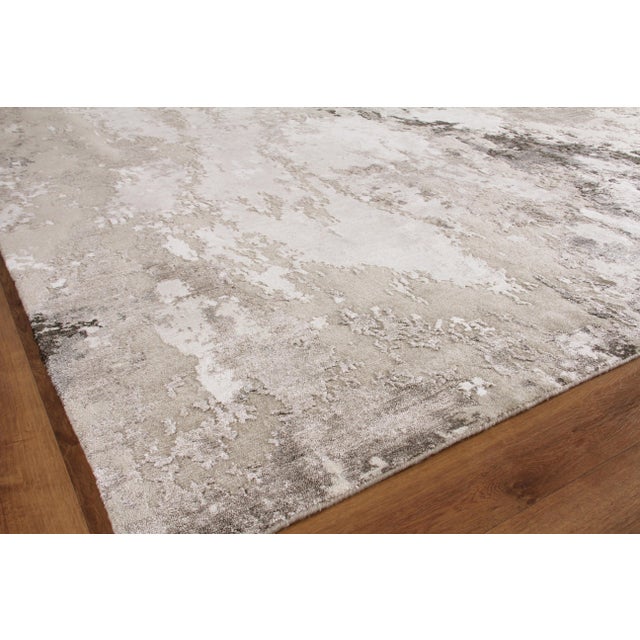 The Cosmo rug is hand knotted and artfully designed of wool and shimmering accents of Bamboo Silk. This remarkable...