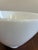 A classic vintage milk glass lamp shade featuring a softly tapered cone silhouette and subtle ribbed detailing near the...