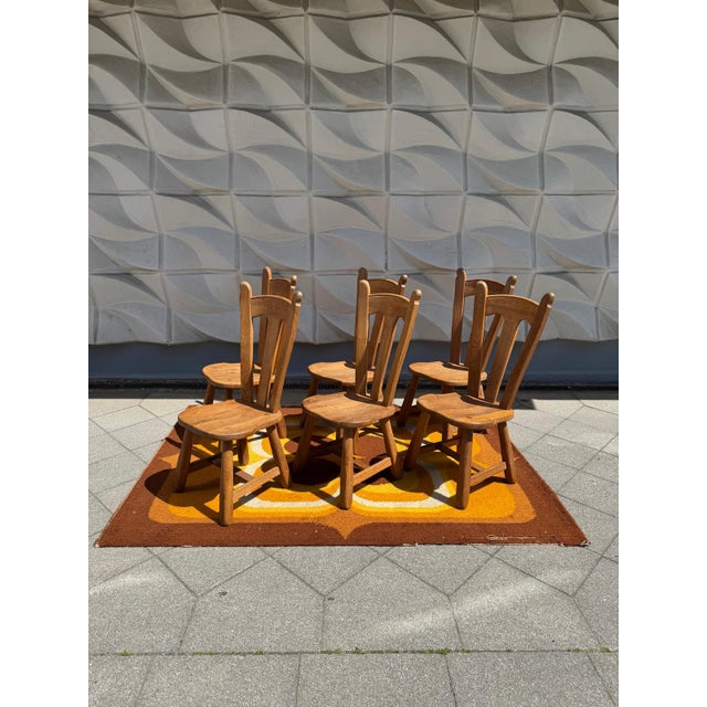 Rare and beautiful Brutalist high-back chairs in solid oak by De Puydt, a Belgian furniture maker from the 1960s. These De...