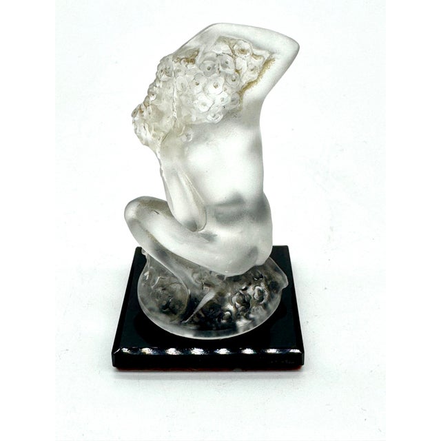 An elegant vintage Lalique France “Floreal” crystal figurine, featuring a beautifully sculpted kneeling nude female figure...