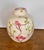 Beautifully detailed vintage porcelain ginger jar / urn featuring an ivory‑white glaze and a raised cherry blossom motif....