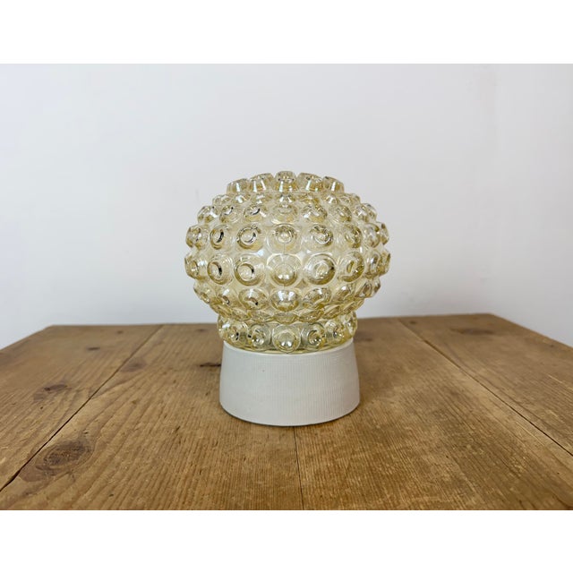 Vintage industrial ceiling or wall light made in former Czechoslovakia during the 1970s. It features a white porcelain...