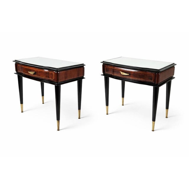 A pair of handmade midcentury Italian nightstands in marquetry style. Each nightstand has a drawer and a glass top. The...
