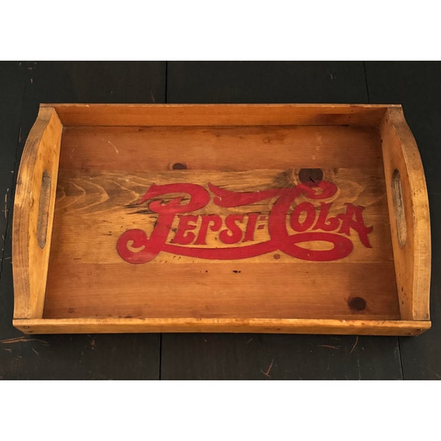 A mid-20th century Pepsi-Cola tray, likely dating to the 1950s, featuring the brand’s iconic script across richly aged...