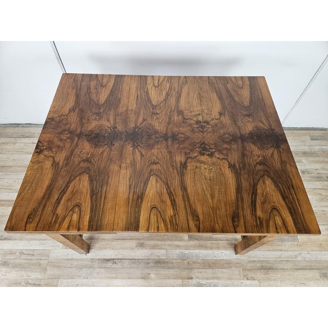 An elegant 1940s Art Deco dining table, featuring a splendid olive burl veneer that lends warmth and refinement to the...