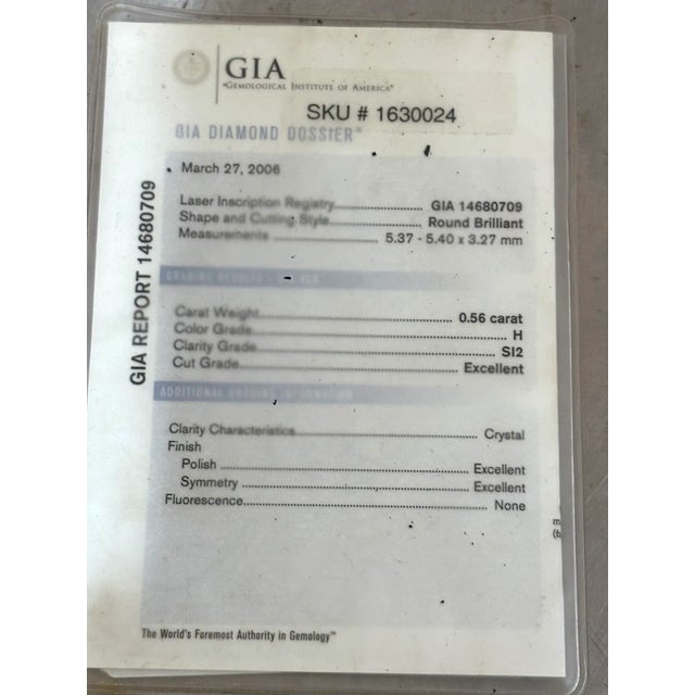 Exquisite 1990s 18 karat gold engagement style ring w/ 1/2 carat center diamond and 8 smaller surrounding diamonds (4 on...