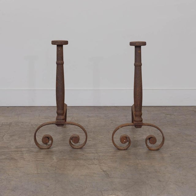 Lovely pair of wrought iron andirons from France, 19th century. Heavy forged iron with arched base and spiral detail....