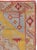 A wool pile of symmetric knots on a cotton foundation. The soft yellow semi-open field presents a beige medallion, pale...