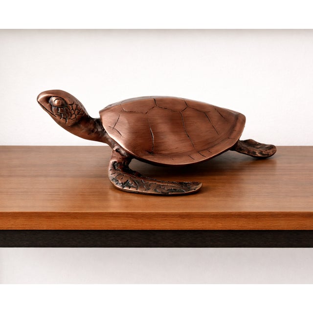 Upgrade your home décor with this striking antique-style sea turtle sculpture, expertly crafted from real metal and...