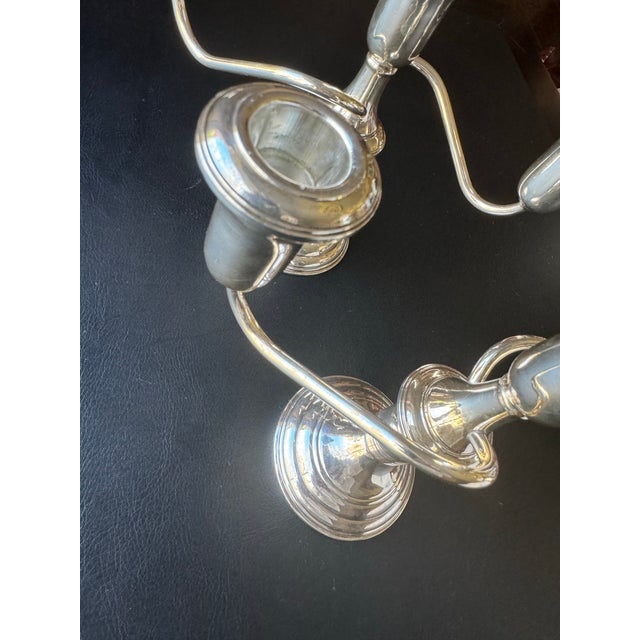 This exquisite pair of Sterling Silver candelabras by Reed & Barton showcases timeless elegance and expert craftsmanship....