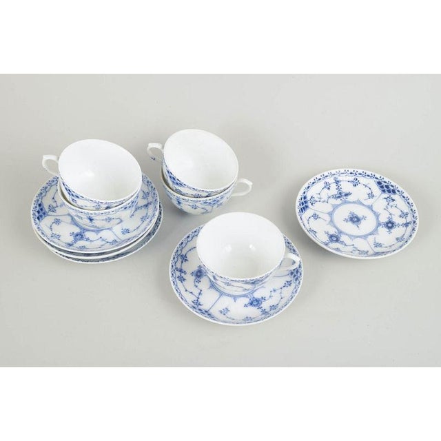 Royal Copenhagen Set of five cups and saucers, 1920s. Classic Blue Fluted Half Lace cups in hand-painted porcelain. The...