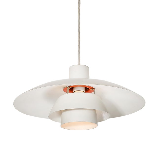 Designed by the renowned Danish lighting manufacturer Louis Poulsen around 1960, this Mid-Century Modernist PH 4/3 pendant...