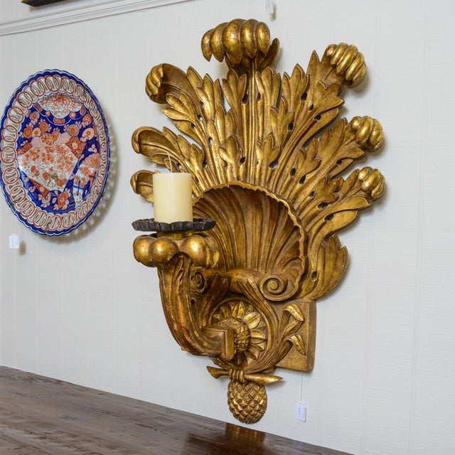 Decorative gold pineapple wall sconce' Carved wood and a very large scale with considerable age.