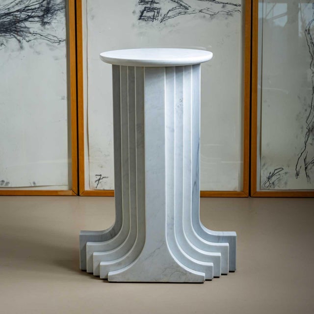 White marble column in a stepped design with a round base. Carlo Scarpa designed this series in 1970 for the Italian...