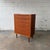 A tall Danish teak chest from the 1960s, with a narrow vertical profile and six graduated drawers that make it especially...