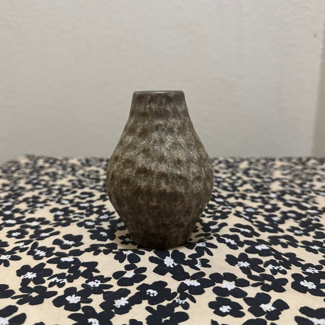 The hammered surface creates depth and visual interest, while the organic shape reflects the individuality of the artist’s...