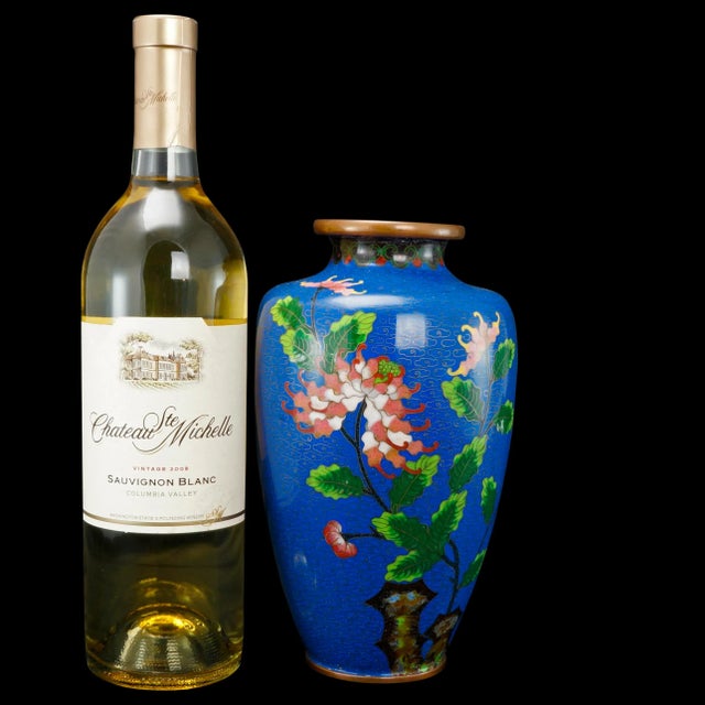 A nicely-sized and colorful Chinese cloisonné Vase with a classic urn shape. A copper vase has been coated in enamels of...