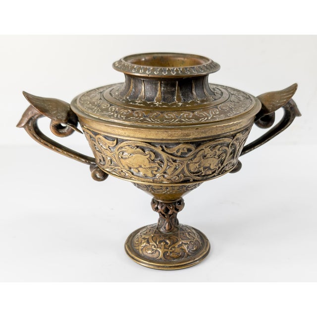 We are selling this unusual and interesting Bronze vase or urn. I’m not entirely sure of the use of this piece beside...