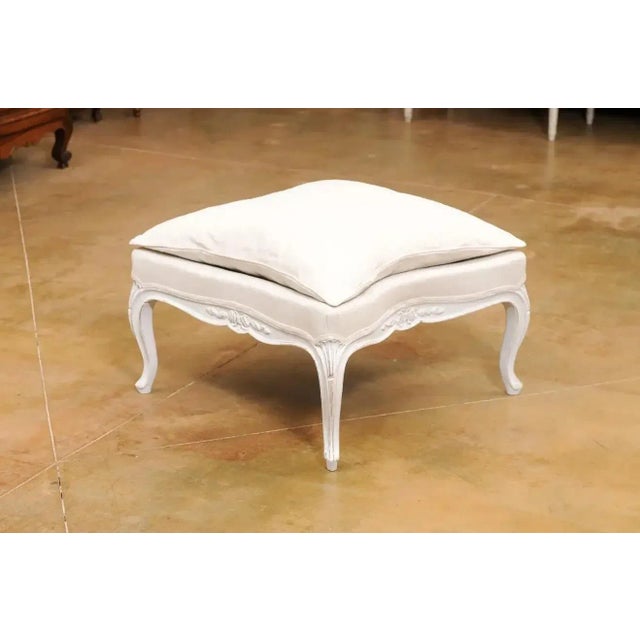 A Swedish Rococo Revival painted wooden stool from the late 19th century, with cabriole legs, carved motifs and new...