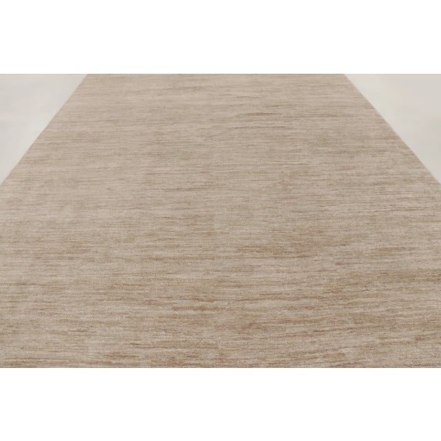 This oversized 10x15 contemporary rug is a refined addition to Rug & Kilim’s Textural collection. Handwoven in linen, it...